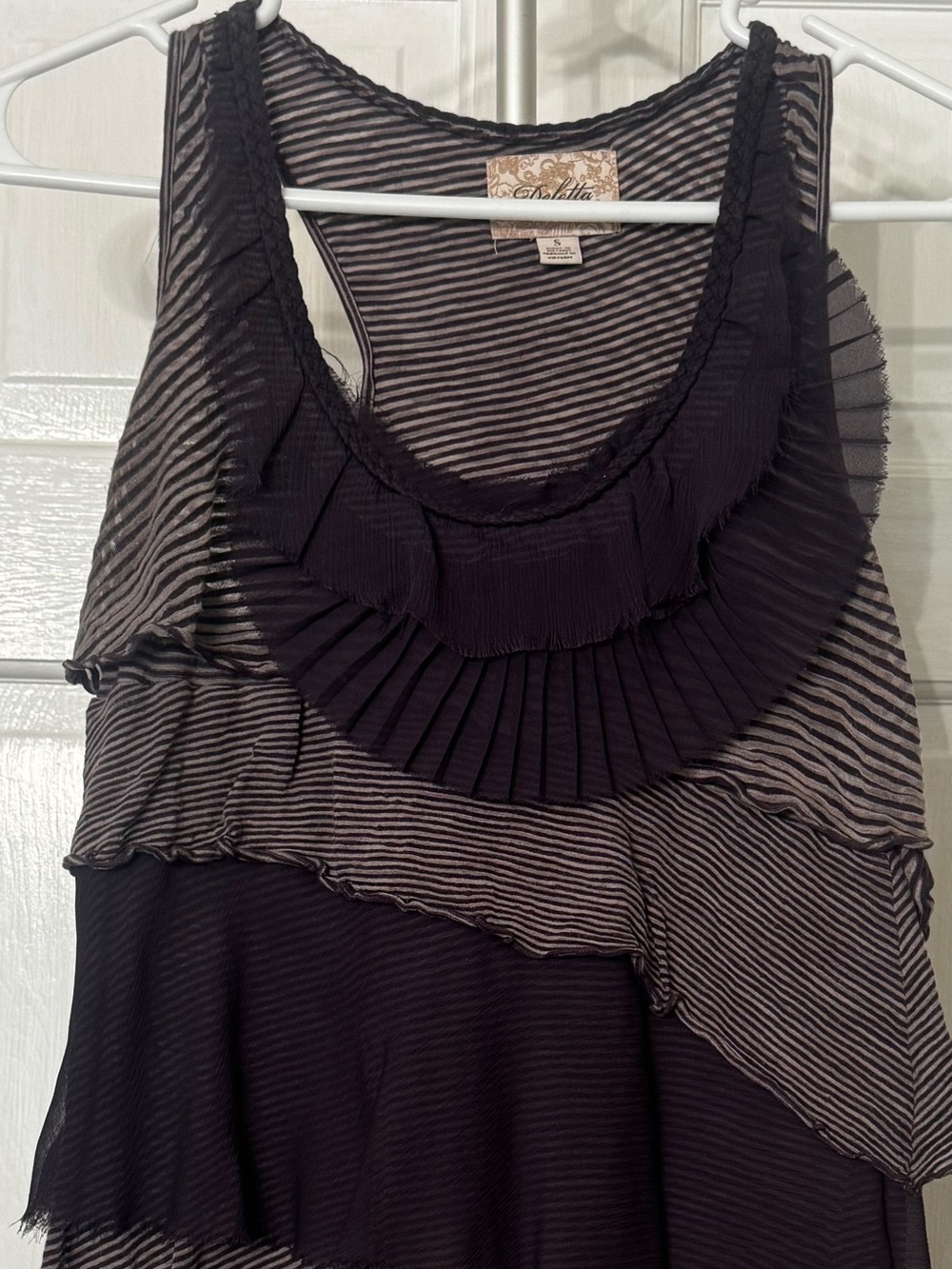 Deletta racerback top with ruffles in darker plum purples.  Small